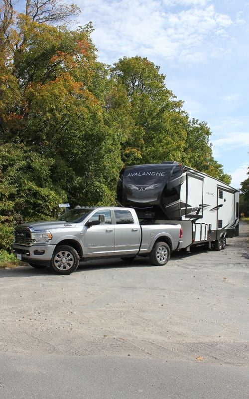 Silver truck towing trailer