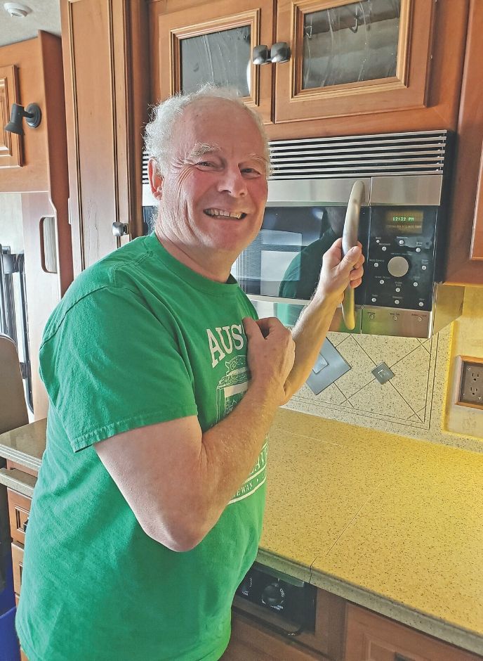 Posing next to a microwave inside the RV