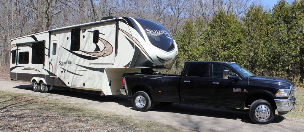 Black pickup truck towing a trailer