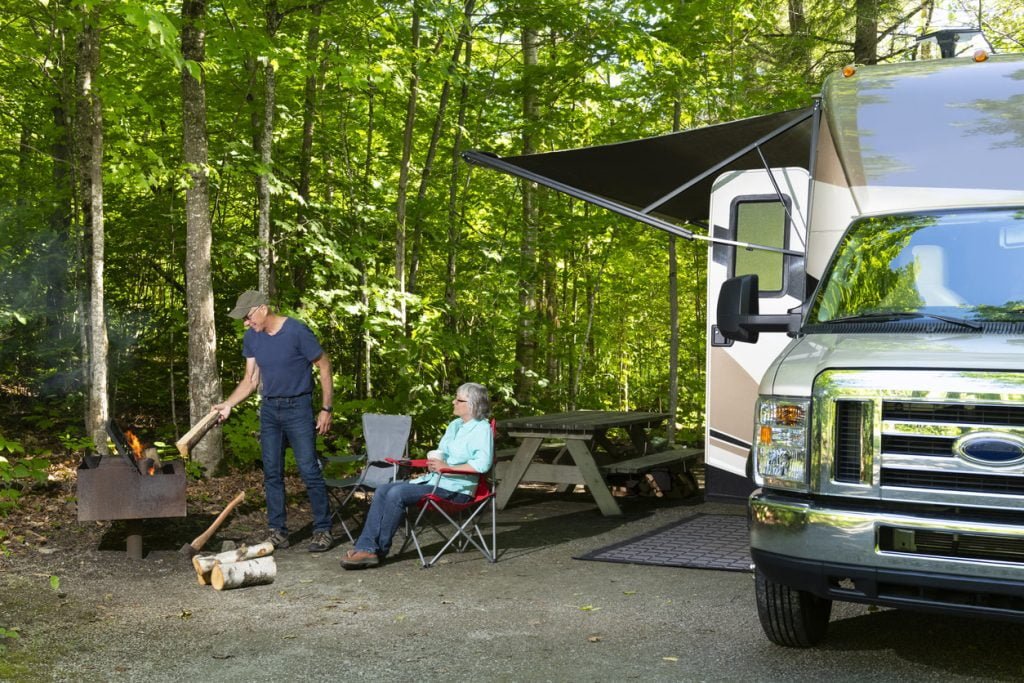 Couple sitting outside of their trailer