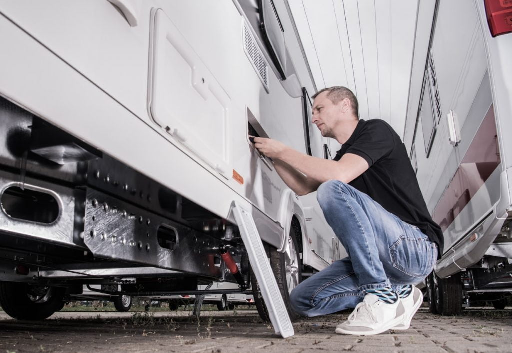 Man checking his water valve on his RV
