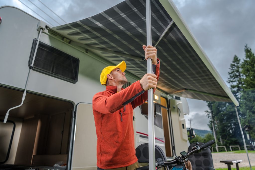 Man setting up trailer awning