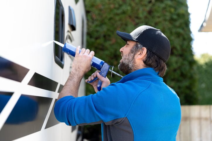 Man insulating the exterior of his RV