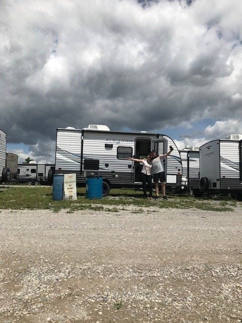 Couple standing in front of trailer