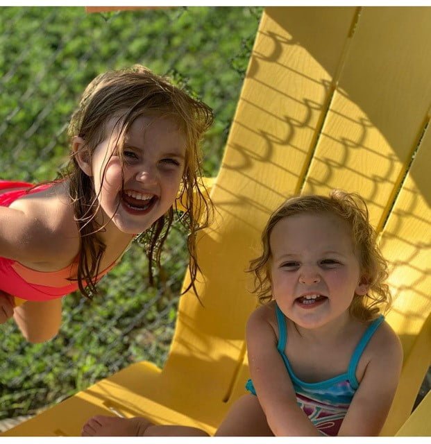 two little girls on a chair