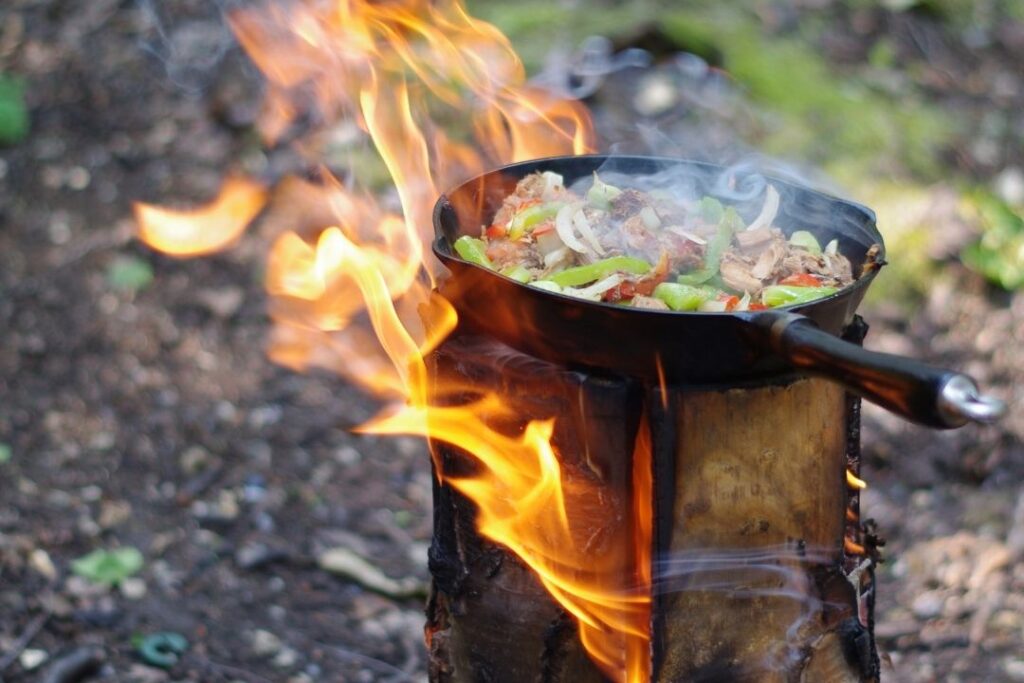 Carnita filling cooking on a swedish log fire