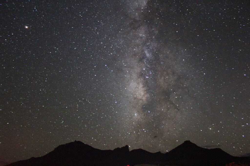 Stars in a night sky over Big Bend, a celestial tourism site.