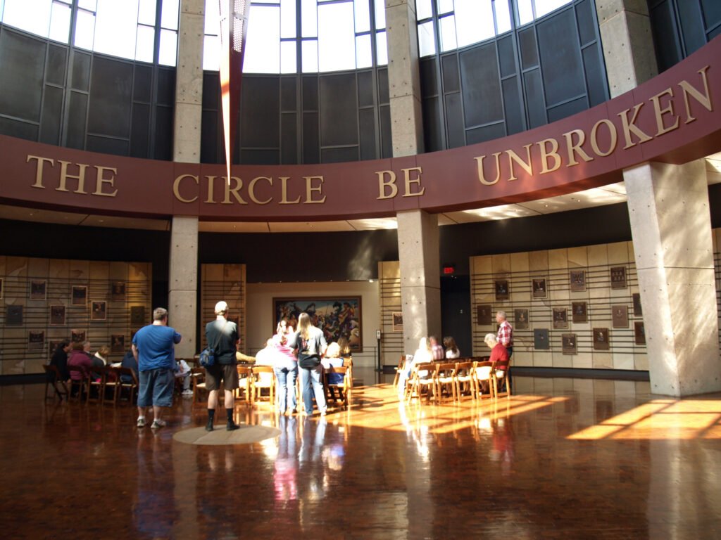 People inside the Country Music Hall of Fame looking at the Circle Be Unbroken sign