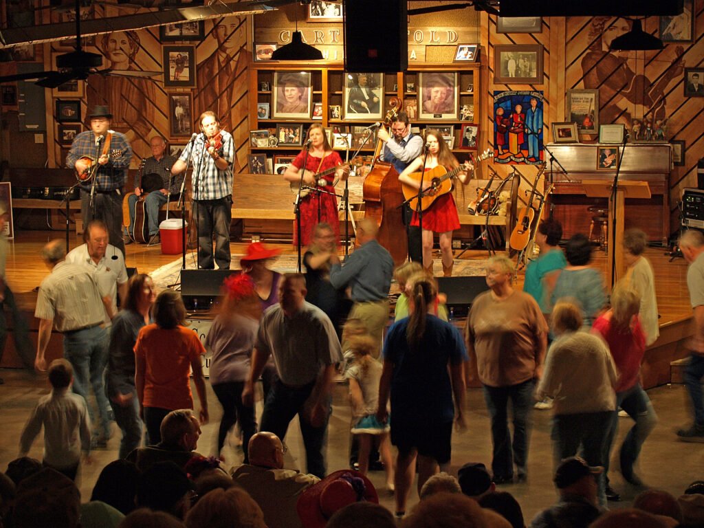 Interior shot of musicians playing and a full dance floor at the Carter Family Fold.