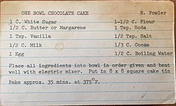Recipe card with ingredients for a one bowl chocolate cake