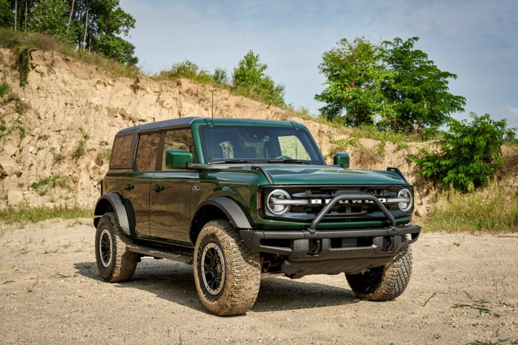 Green 2022 Ford Bronco SUV parked on a dirt path.