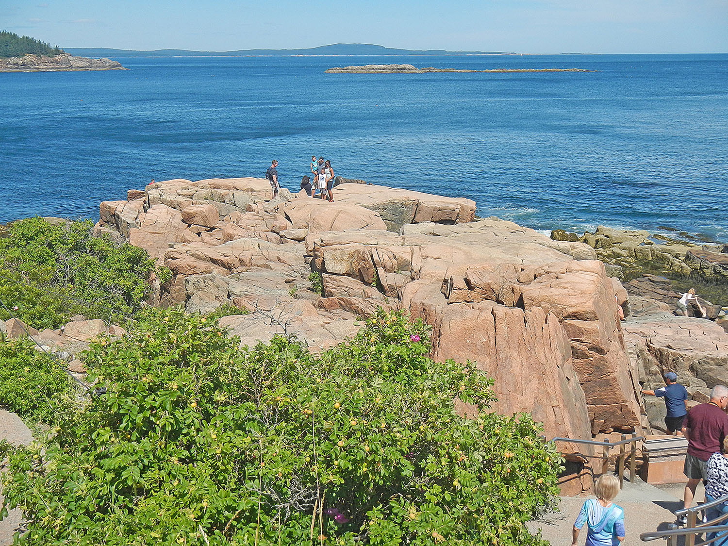 People exploring Thunder Hole in Acadia National Park, one of the more popular lookout points and a Maine landmark.