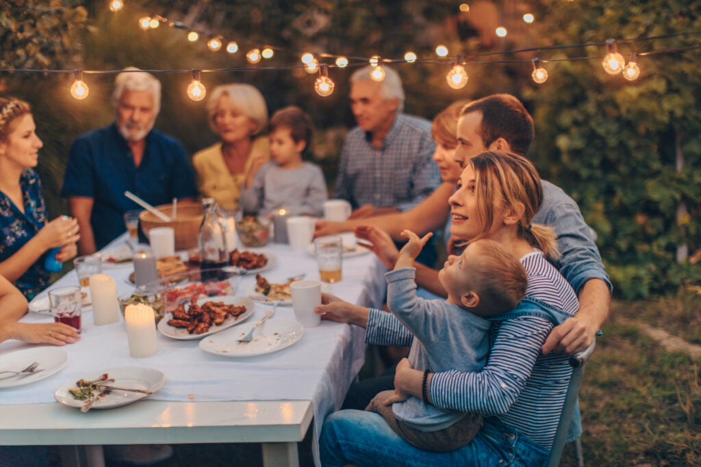 Family enjoying a group meal outside.