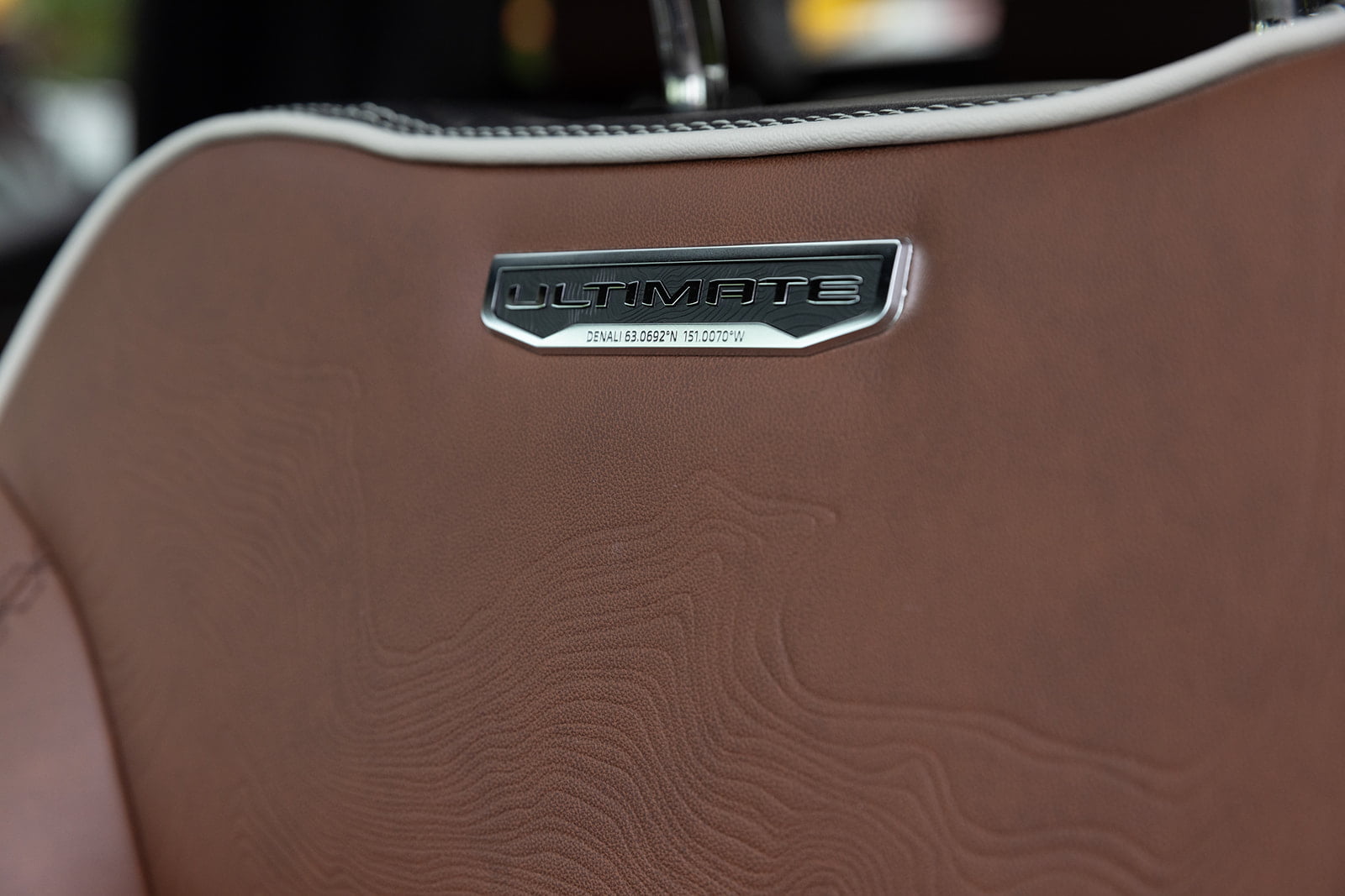 “Ultimate” badging on leather front seats in a GMC Sierra Denali Ultimate.