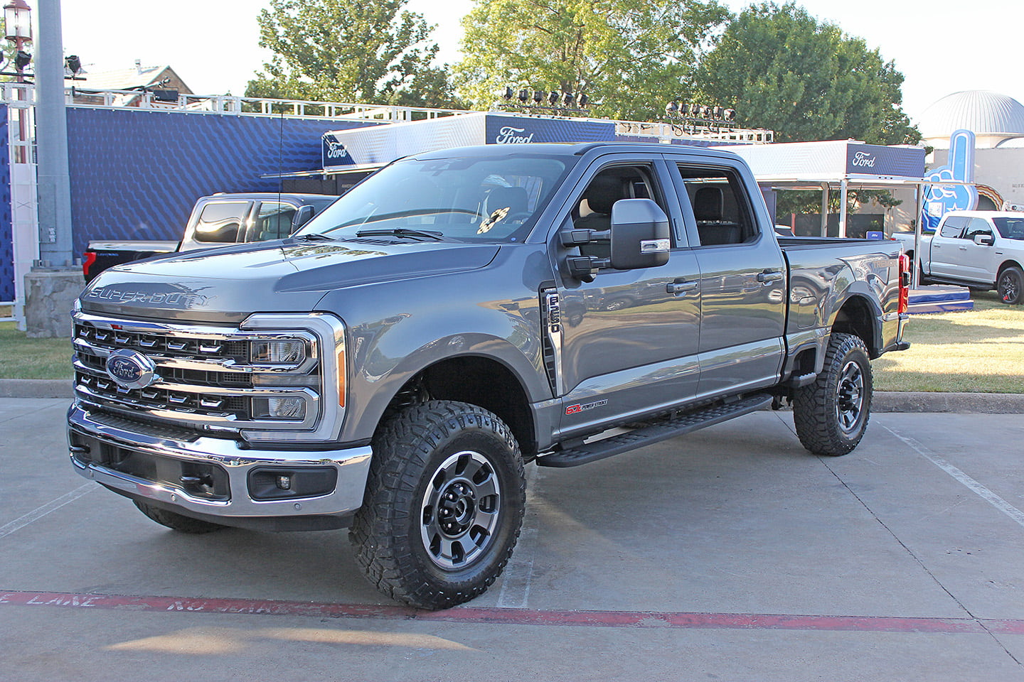 The exterior of the 2023 Ford Super Duty in grey, at an angle from the front end and looking at the driver’s side.
