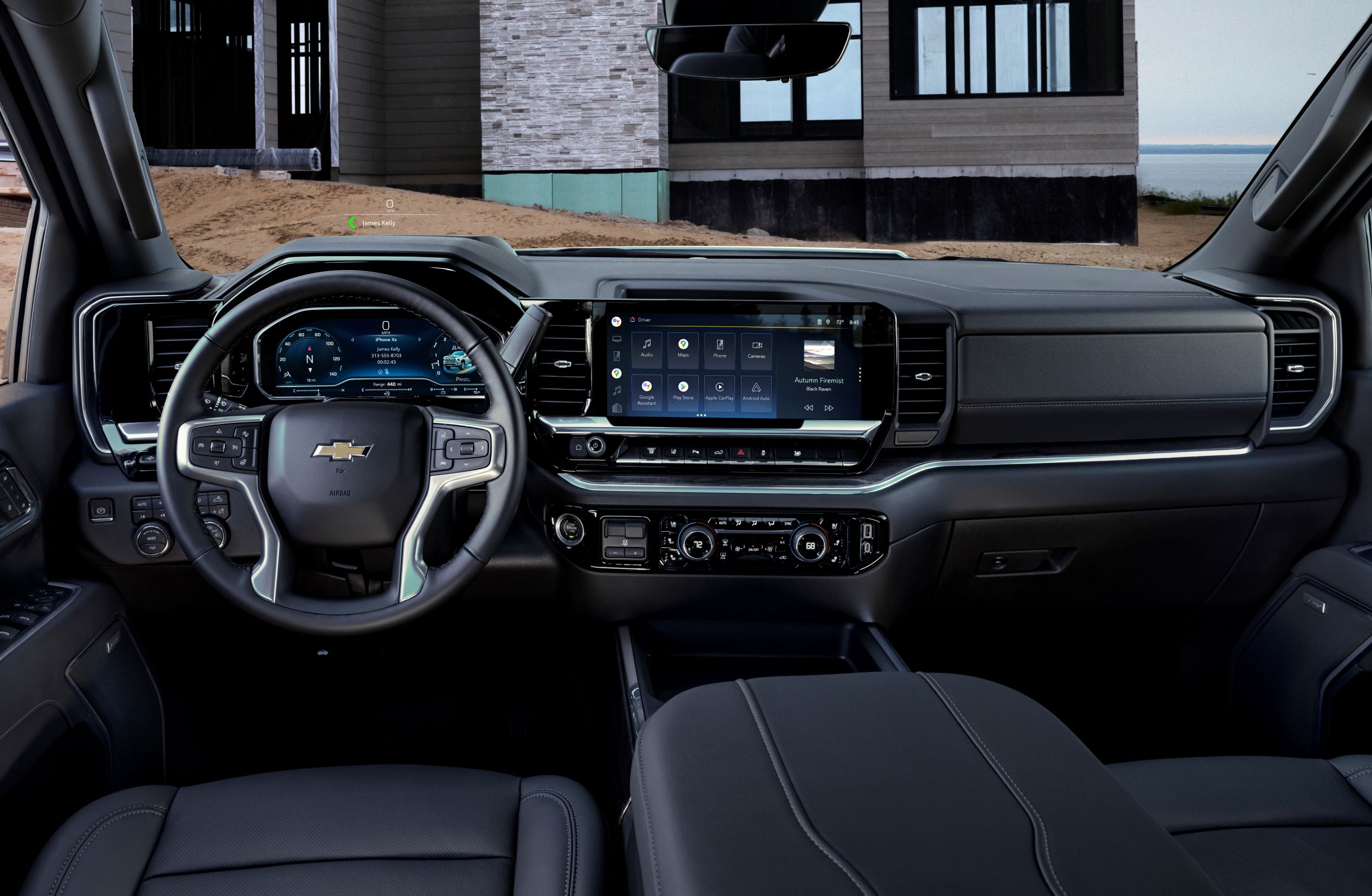 The inside of a 2024 Chevrolet Silverado, featuring black leather interior and a large touch screen. 