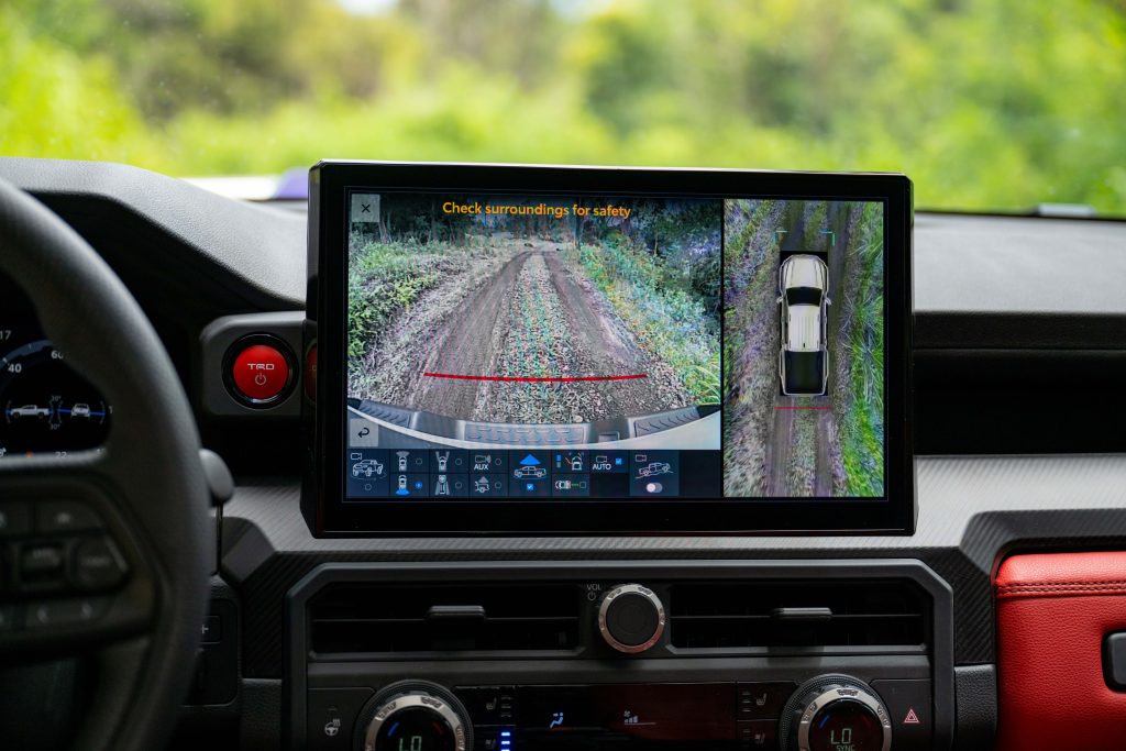 Rear view of a Toyota Tacoma Procam, showcasing its rugged design and sturdy construction. Aerial view of a Toyota Tacoma Procam, traversing a scenic landscape with its adventurous spirit and off-road capabilities.