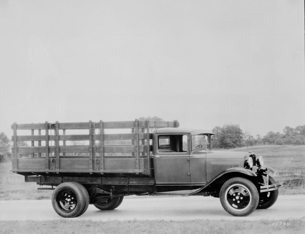 A black Ford 1930 Model A Roadster pickup truck. The vintage vehicle showcases the classic Model A design, featuring an open-top roadster style and a pickup truck bed at the back.