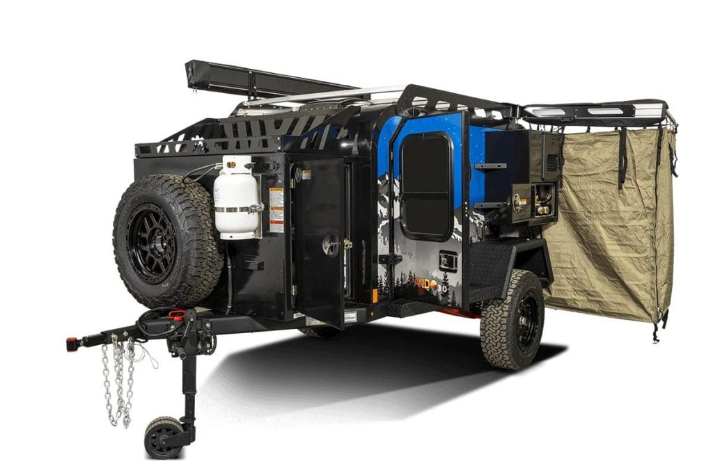 Front side view of the exterior of the Off Grid Trailer – Expedition 3.0, showing the hitch, spare tire, propane tank and all exterior storage.