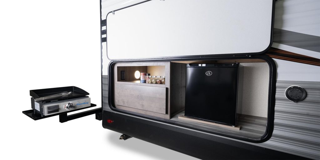 An image of the back of the trailer with the back hatch and grilling station opened. 