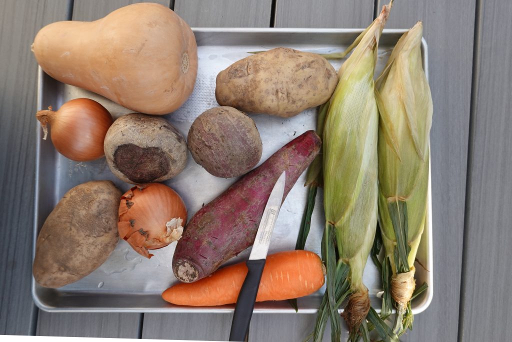 Choose your vegetables for fire roasting. Here are Butternut squash, Russet potatoes, beets, corn, carrot, and onions.