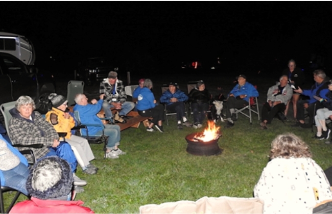 Explorer RV Club members gathered around a fire at the Explorer RV Club 2024 National Rally.