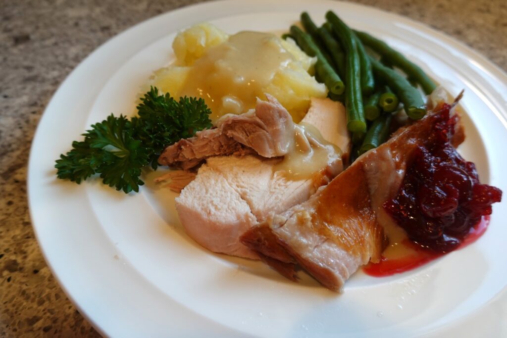 BBQ turkey with mashed potatoes, gravy and homemade cranberry sauce.