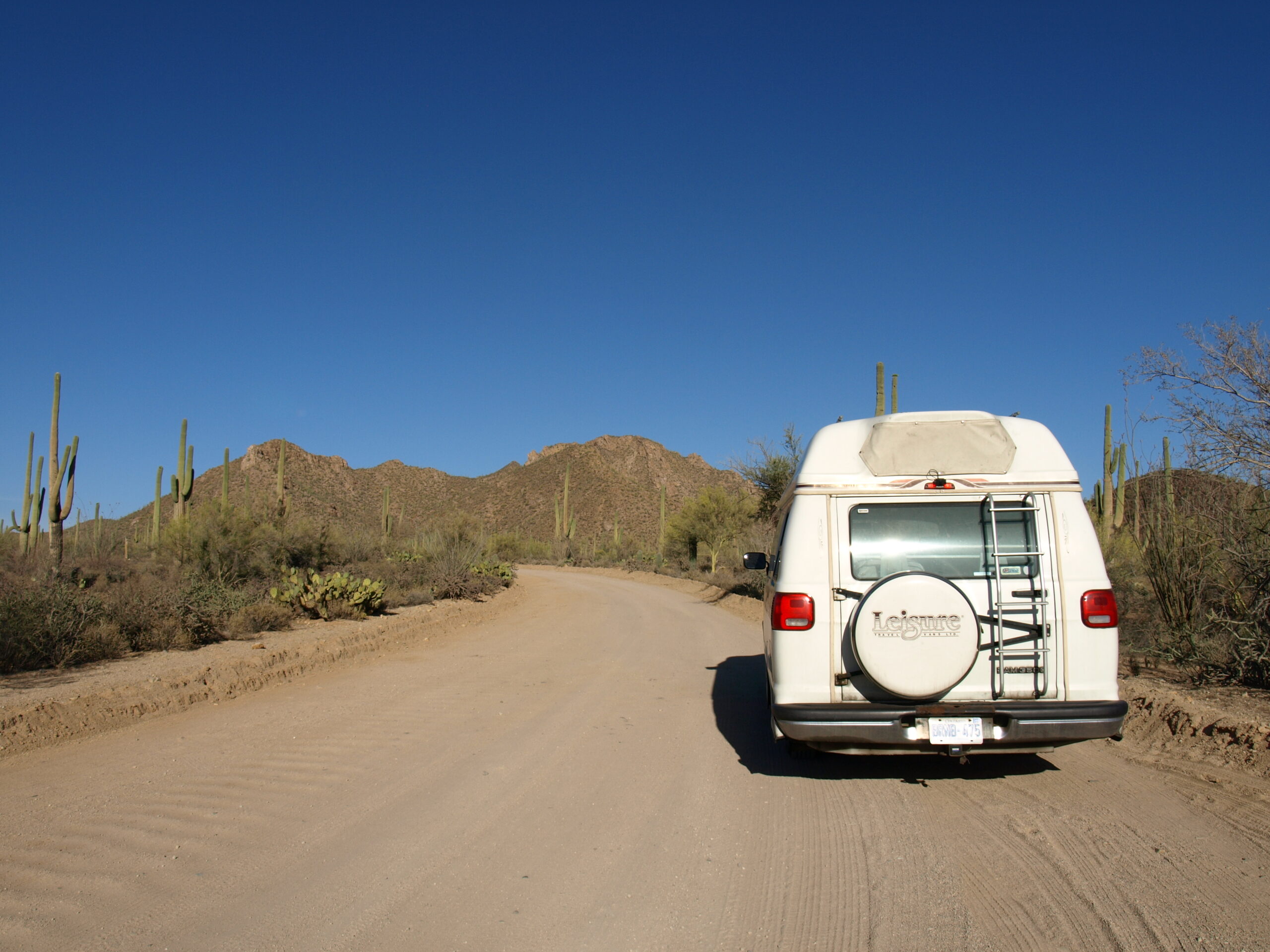 An RV parked on a dirt road in the Arizona Desert