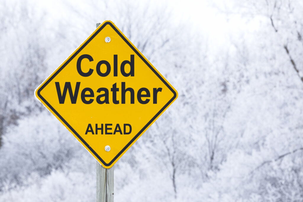 A road sign that reads “cold weather ahead”.