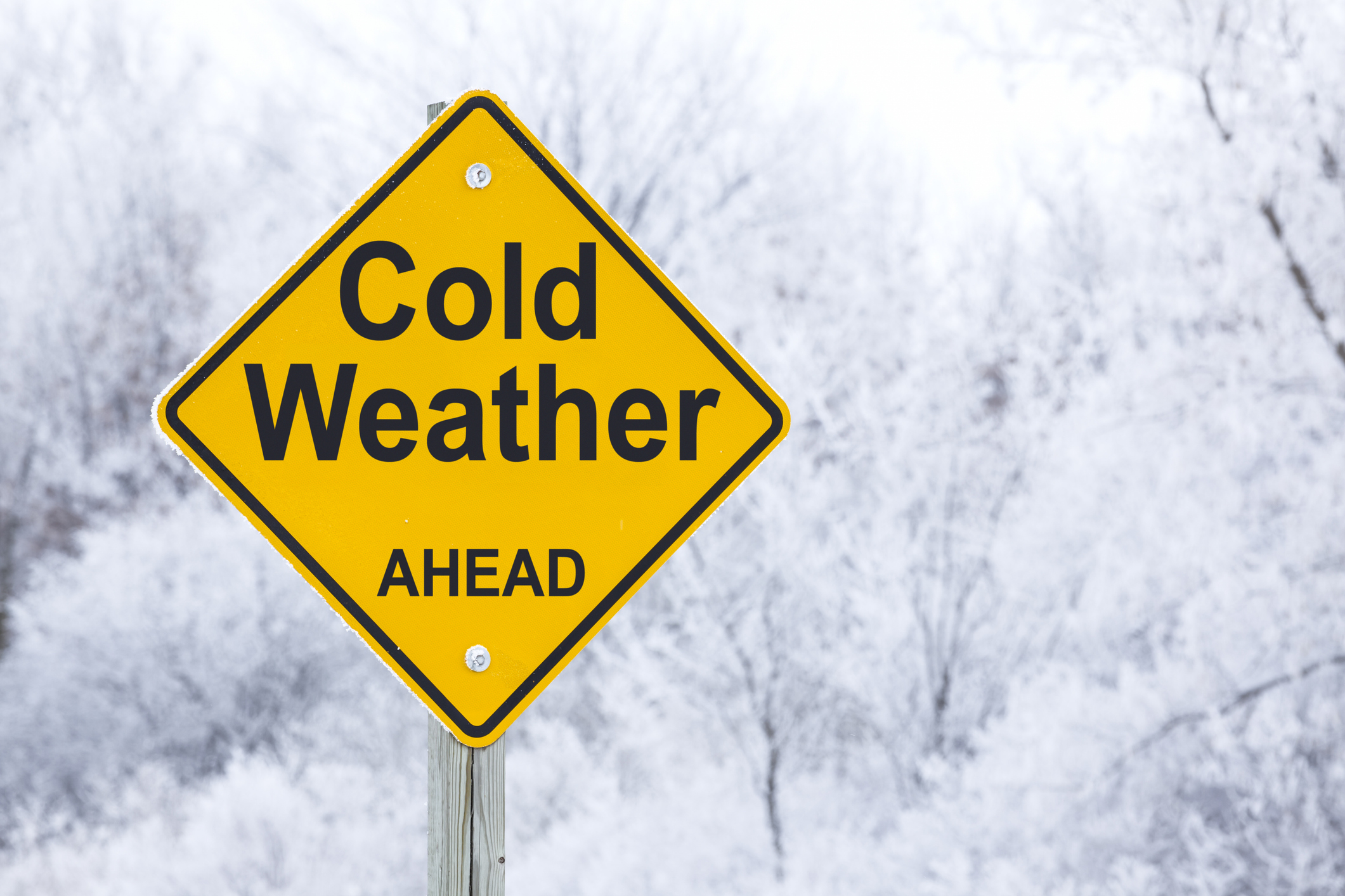 A road sign that reads “cold weather ahead”.