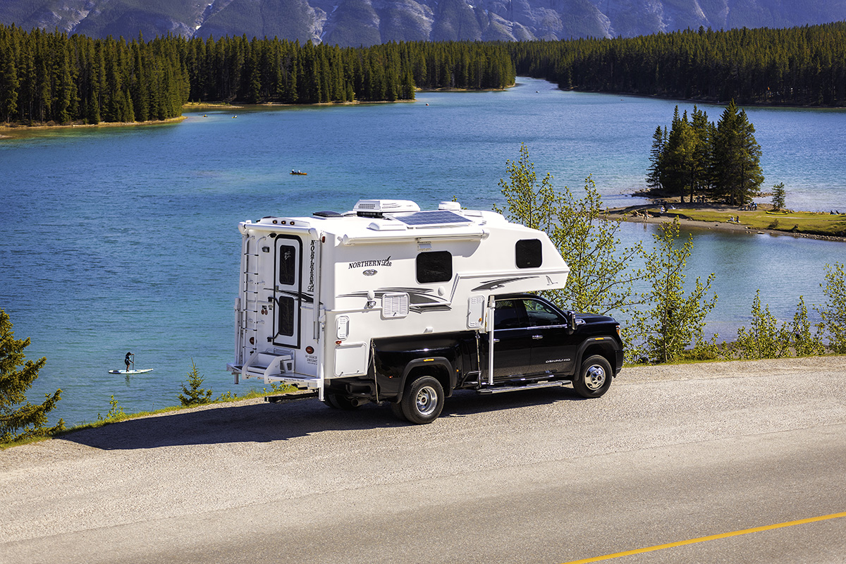 Northern Lite truck camper by the lake