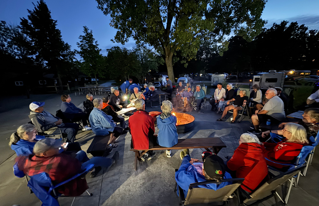 Explorer members gathered around a campfire at the Explorer Rally.