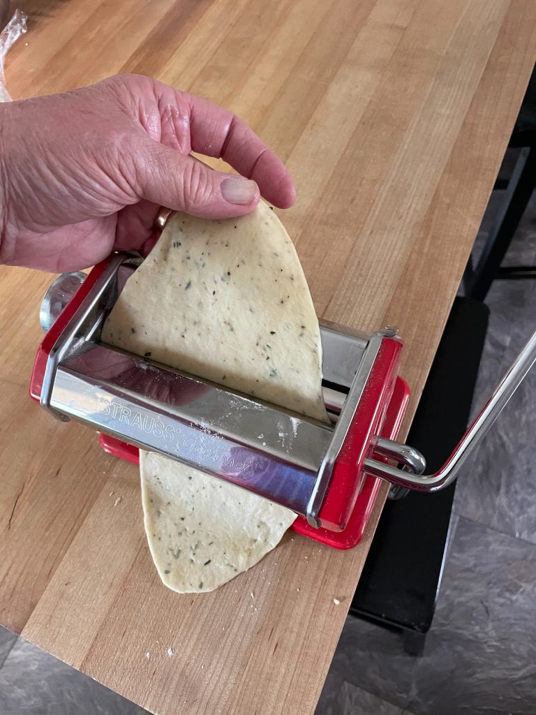 A pasta roller used to roll thin sheets of dough for crackers.