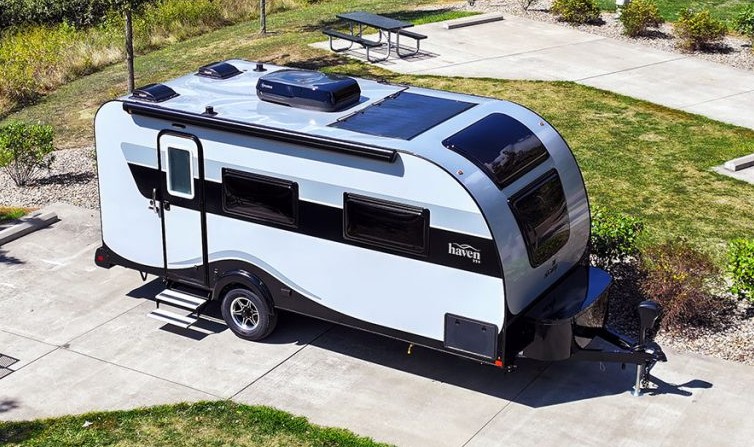 The 2026 Nu camp Haven 220 is seen sitting on a concrete campsite on a nice sunny day.