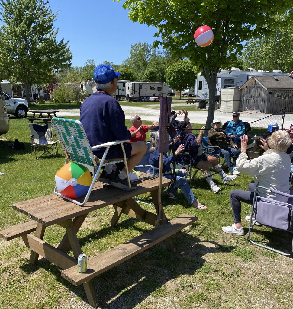 Group playing chair volleyball outdoors.