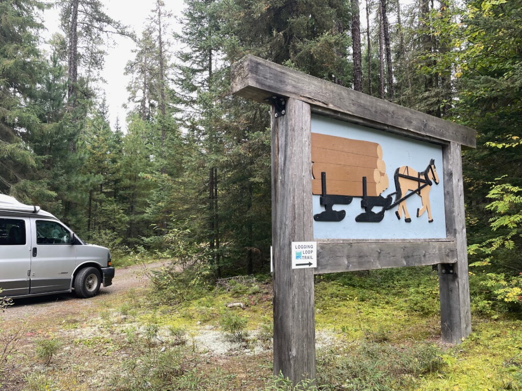 An RV parked at the entry to the Historic Logging Exhibit Trail.