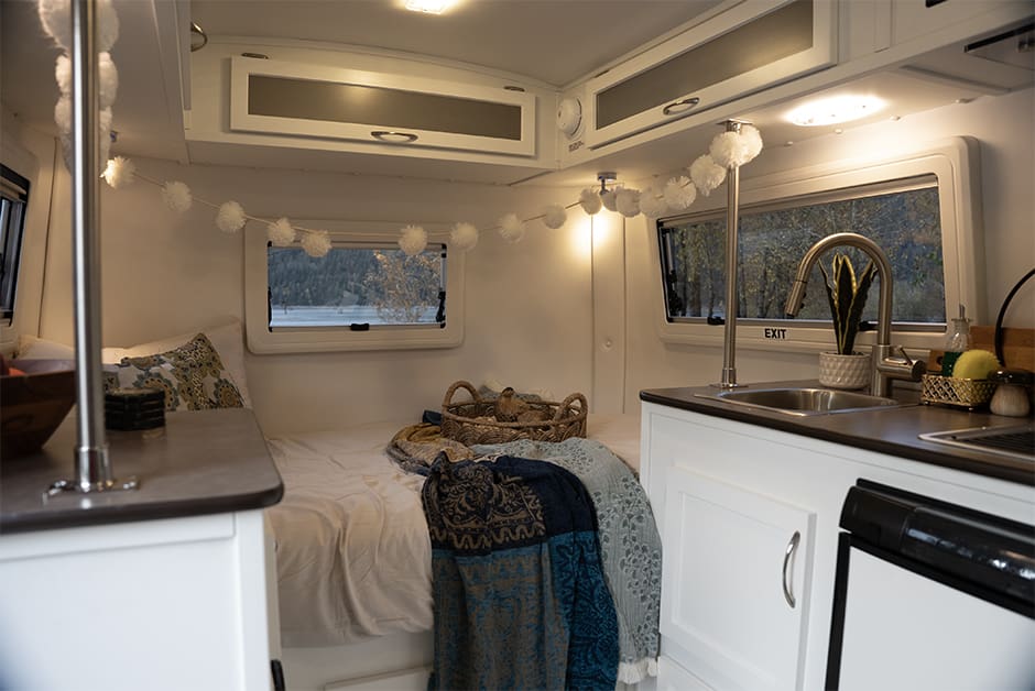 Escape E13 interior showing convertible dinette and sleeping area.