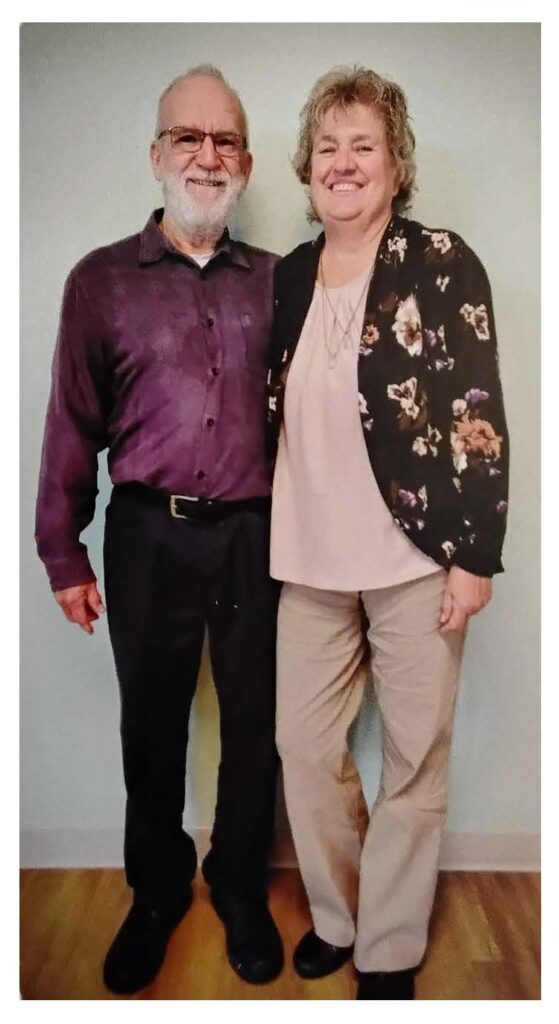 Couple portrait of RV club members indoors.