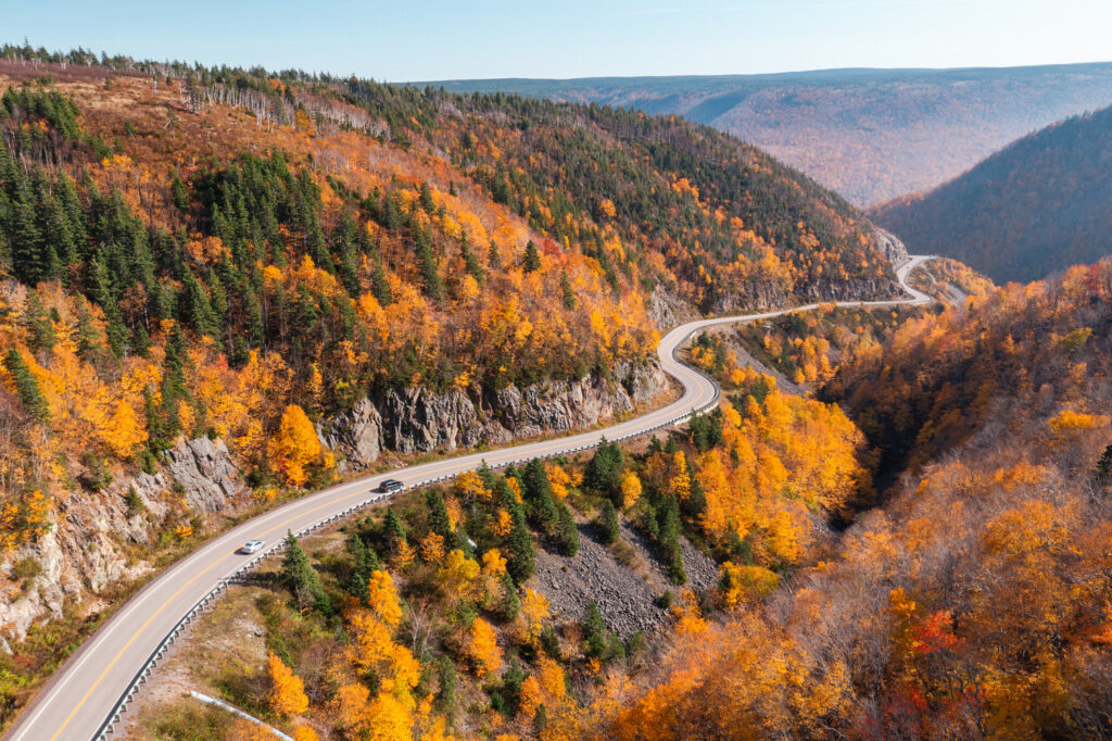 Cabot Trail road winding through Cape Breton fall colours in Nova Scotia