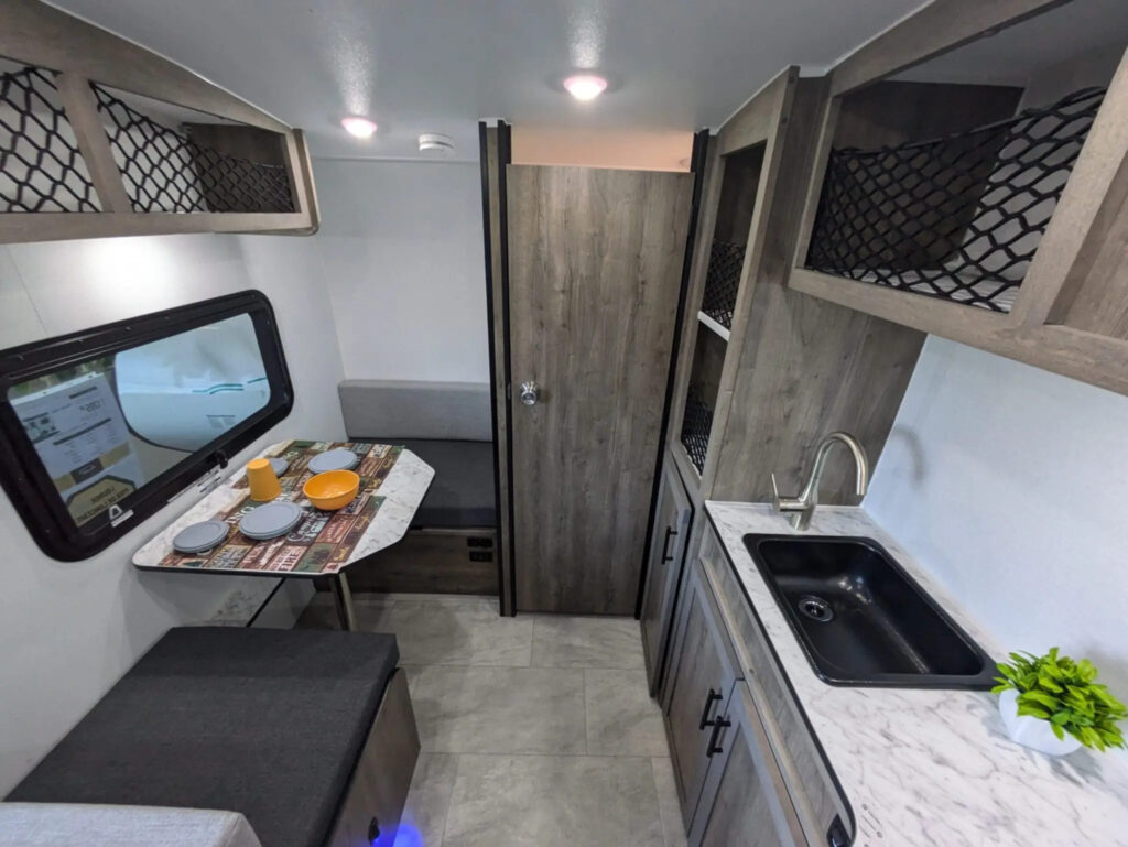 Compact Prolite Lounge Eco trailer interior kitchen and dinette.
