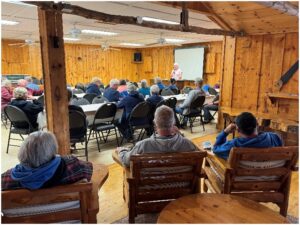 An Explorer RV Club member shares travel information during a rally presentation.